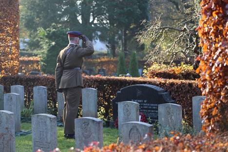 A statue of a person in a cemetery  Description automatically generated with low confidence